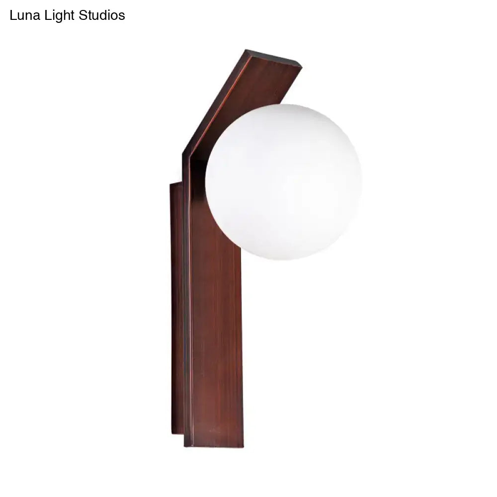 Modern wall sconce with dark bronze frame and smooth milk glass shade for dining room lighting