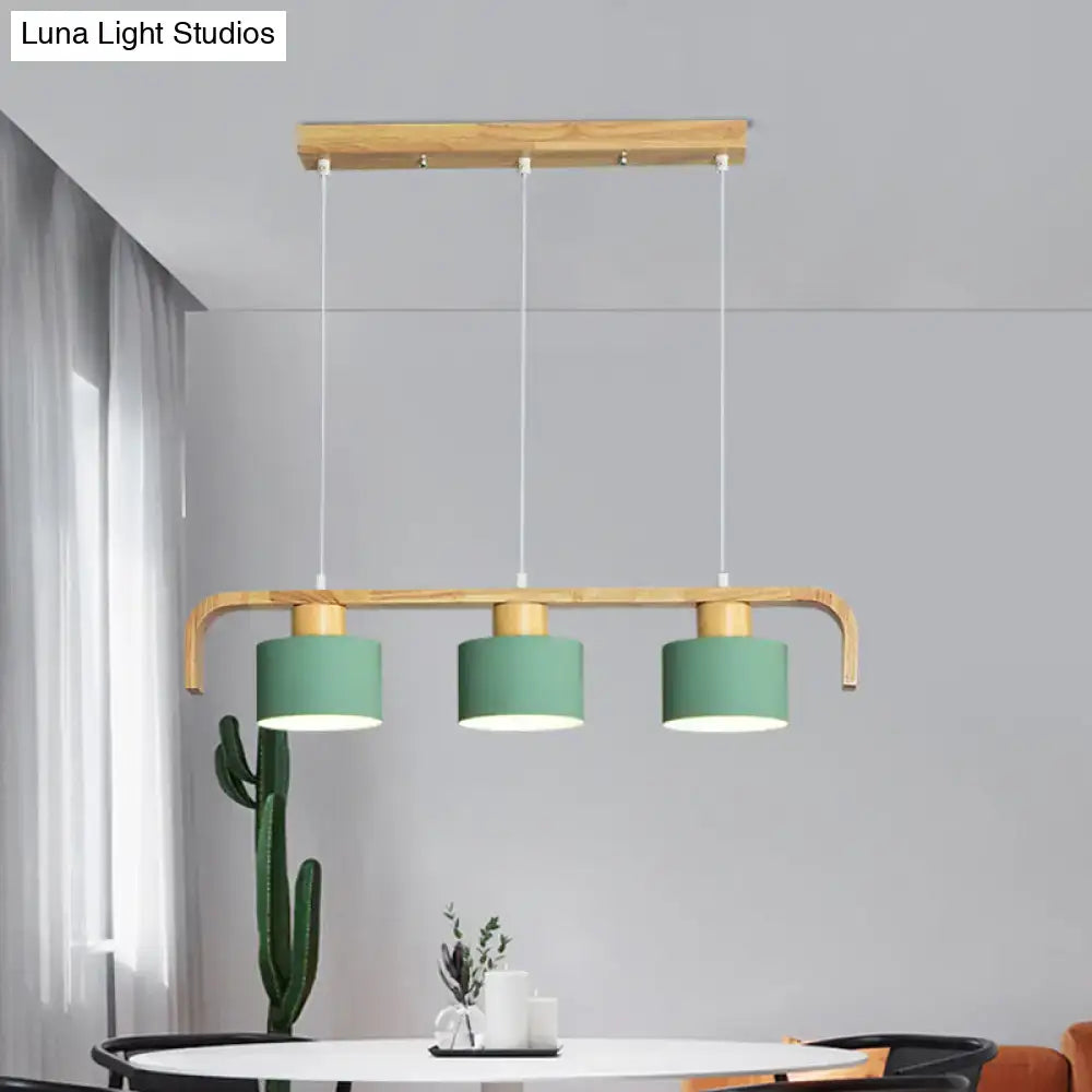 Modern wood and mint green 3 light chandelier with matte sage green shades and natural wood frame for dining room kitchen