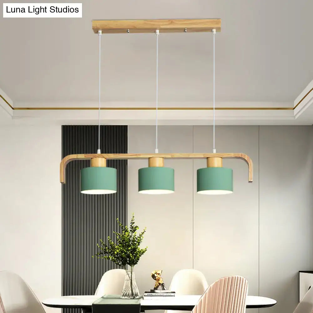 Modern wood and mint green three-light pendant lamp with matte teal shades and white cords for dining room kitchen use