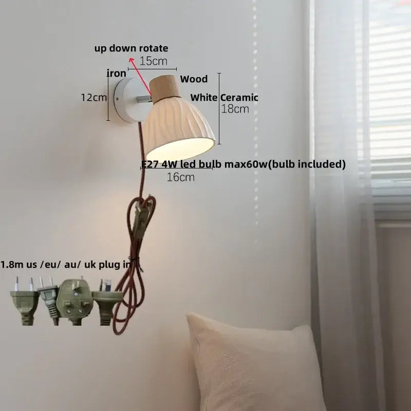 A modern wall light fixture with a white ceramic shade, wooden top accent, and iron mounting bracket for bedrooms