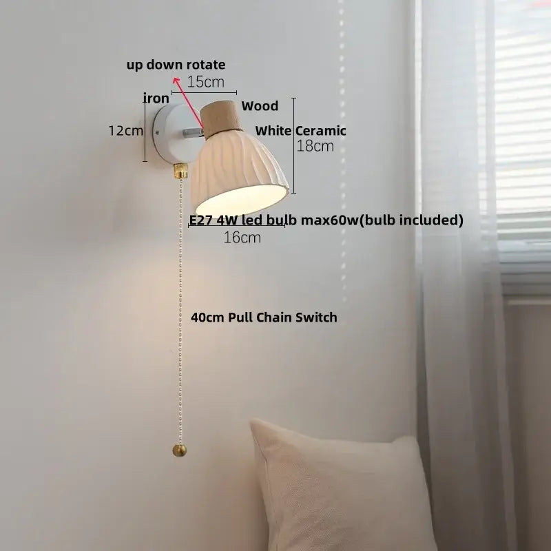 A modern wall light fixture with a white ceramic shade, wooden top accent, and iron mounting bracket for bedroom use