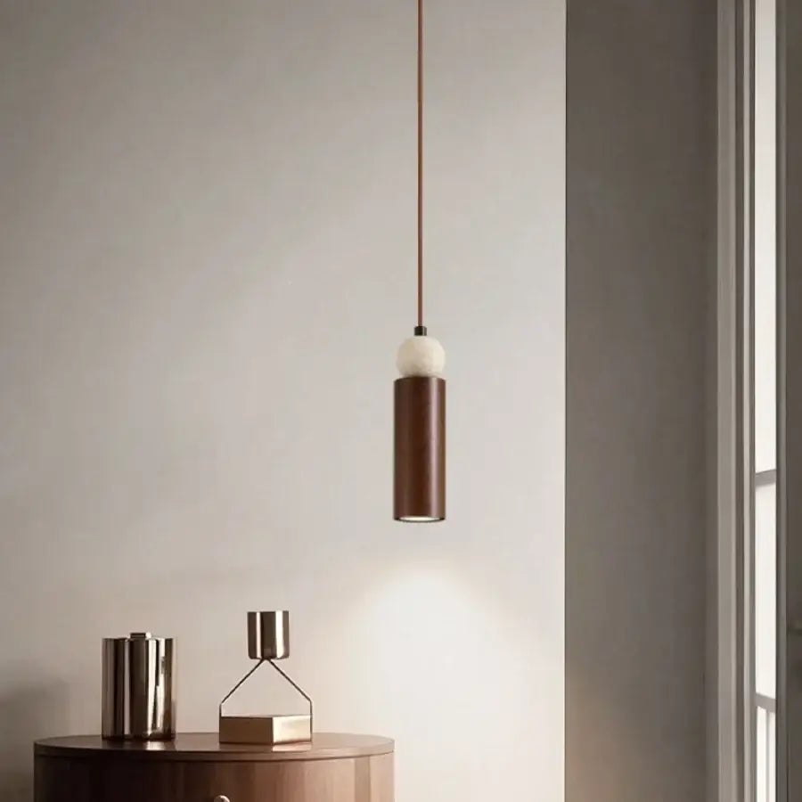 Modern wood and travertine iron led pendant light with cylindrical brown metal body and white spherical diffuser for living room decorbites iron led