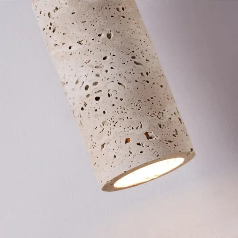 Modern wood and travertine led wall lamp with cylindrical concrete pendant and warm speckled textured glow