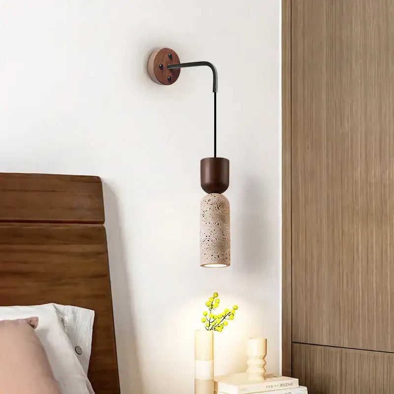Modern wood and travertine led wall lamp with dark bronze base and speckled beige stone shade for bedroom sconce