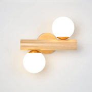 Modern wood and white glass ball rotating wall sconce with brass accents and two frosted white glass ball shades