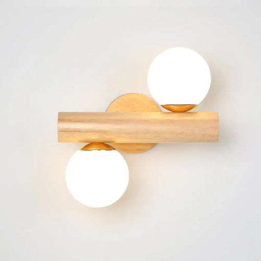 Modern wood and white glass ball rotating wall sconce with brass accents and two frosted white glass ball shades
