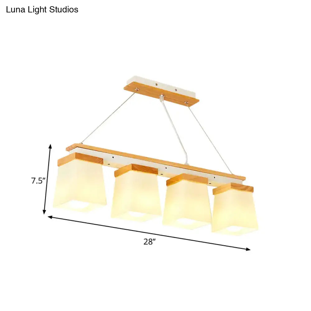 Modern wooden-framed pendant light with four warm white lights and square frosted glass shades for dining room use