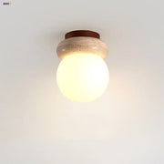Modern wood base led ceiling light with warm-toned glass globe on beige stone base and dark brown wooden ring decorbites ceiling light
