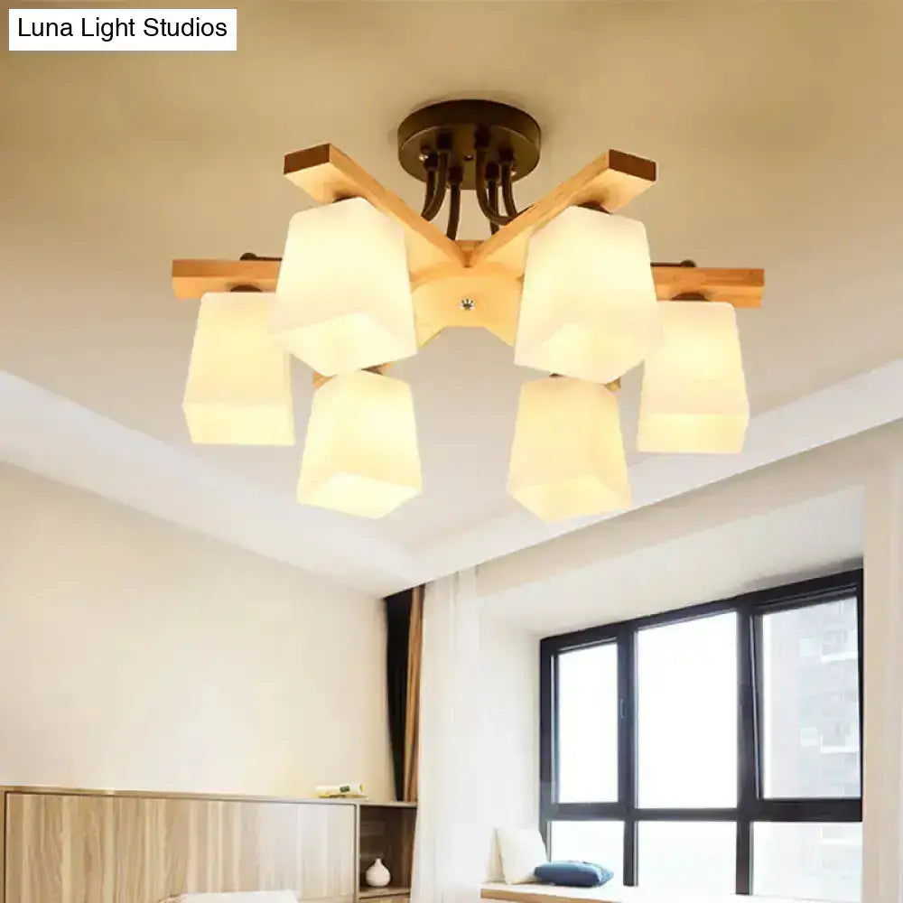 Modern wood and black semi flush mount living room light with six warm-toned milk glass shades and geometric design