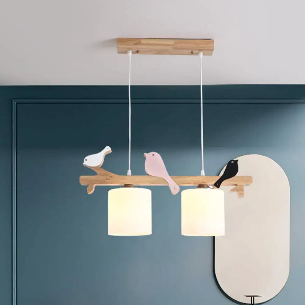 Wooden branch pendant light with three painted birds and cream frosted glass shades for modern kitchen island or barrel island lighting