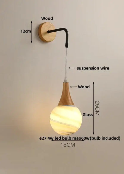 A warm amber-hued glass pendant lamp with wooden stem for modern cube led wall lights bedroom sconce