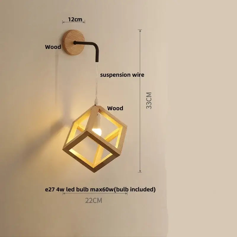 A warm-toned wooden cube led wall light with black metal arm and suspension wire for modern bedroom sconce lighting