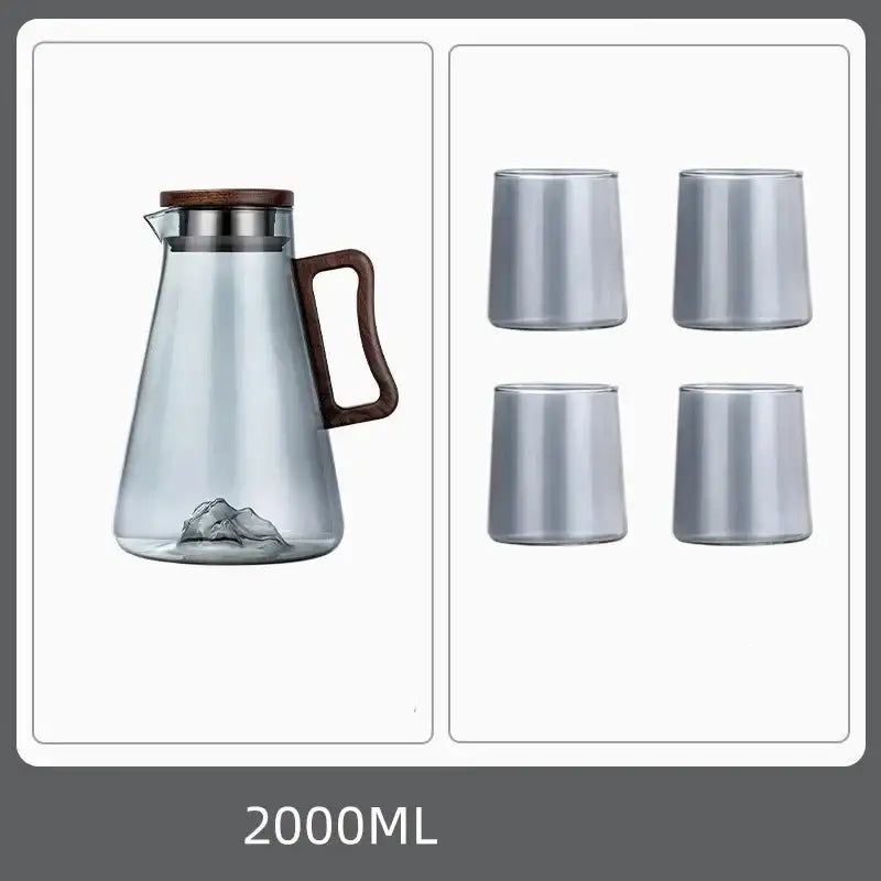 Modern glass cold water jug with wooden handle and lid accompanied by four metallic tumblers for kitchen use