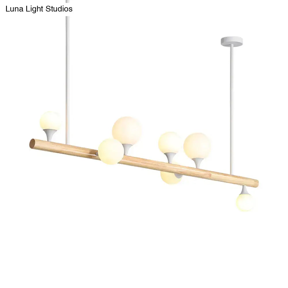 Modern wood island lamp with natural wood beam and five frosted glass globe bulb bases for dining room lighting