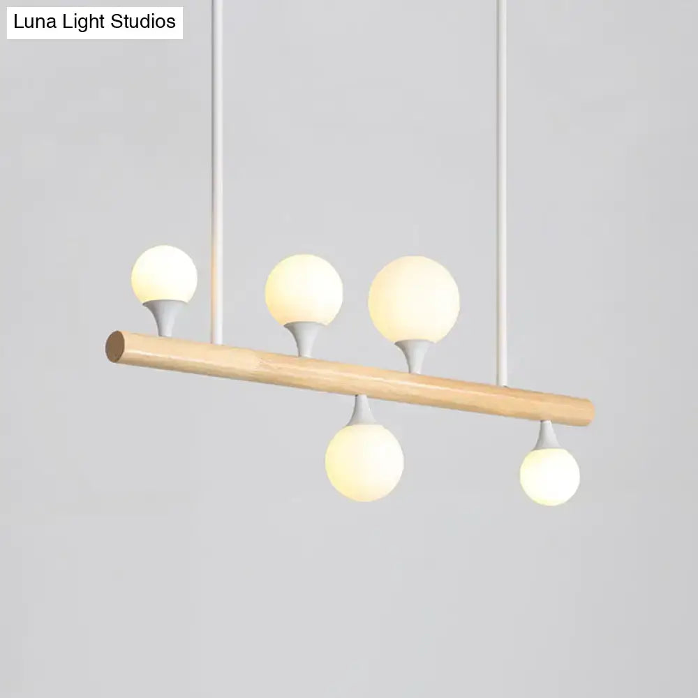 Modern wood island lamp with natural wood bar and five frosted glass globe bulbs for dining room bulb base lighting