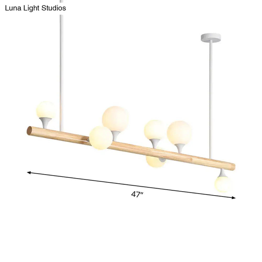 Modern wood island lamp with natural wood rod and five frosted glass globe bulbs for dining room use
