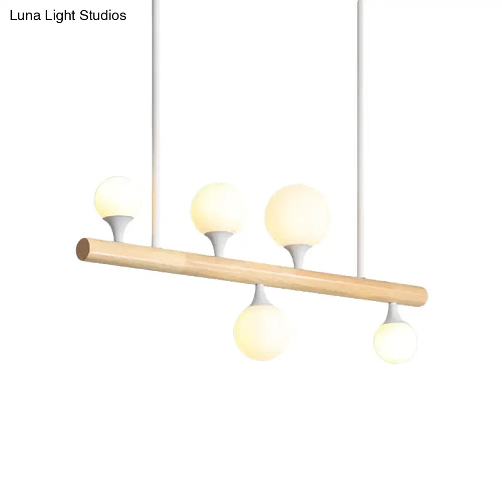 Modern wood island lamp with natural wood bar and four frosted glass globe bulbs perfect for dining room bulb base