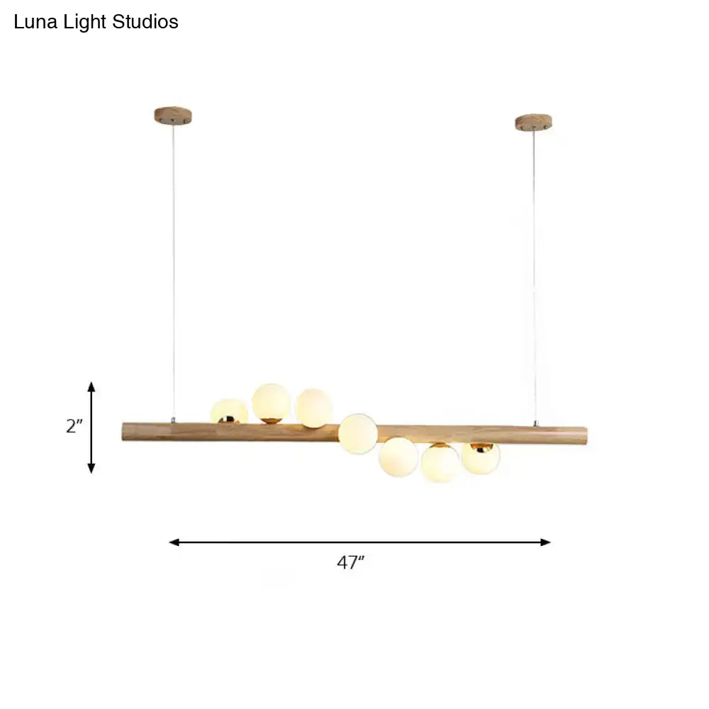 DecorBites modern wood ceiling light with seven frosted opal glass globes and brass accents for dining room fixture height