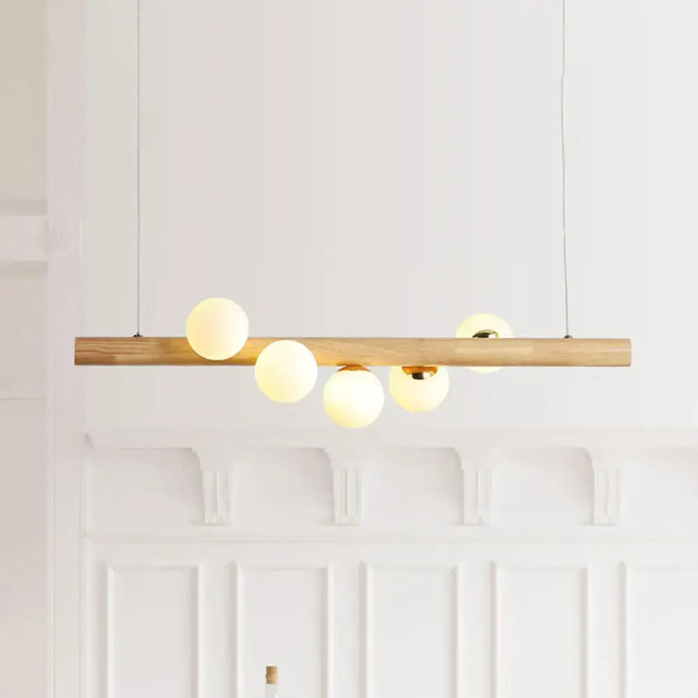 DecorBites modern wood island ceiling light with opal glass spherical shades and adjustable fixture height for dining room