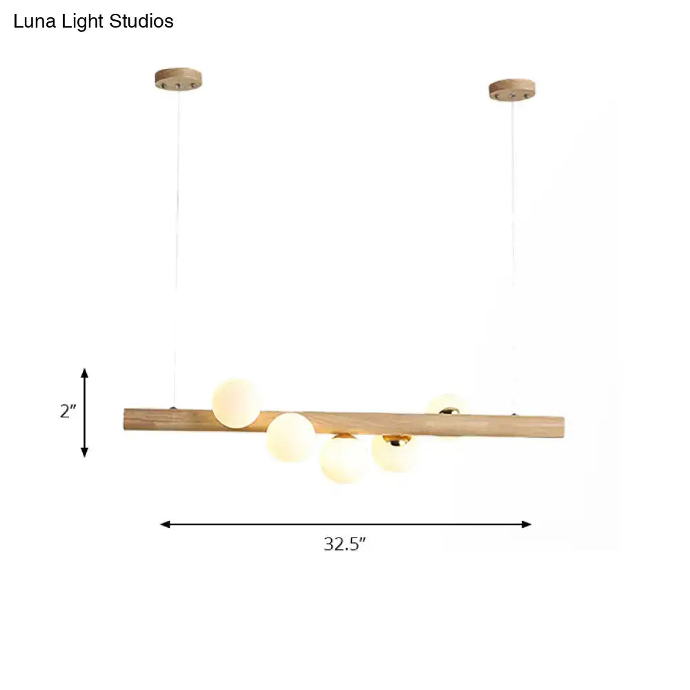 DecorBites modern wood island ceiling light with opal glass globes and adjustable fixture height for dining room use