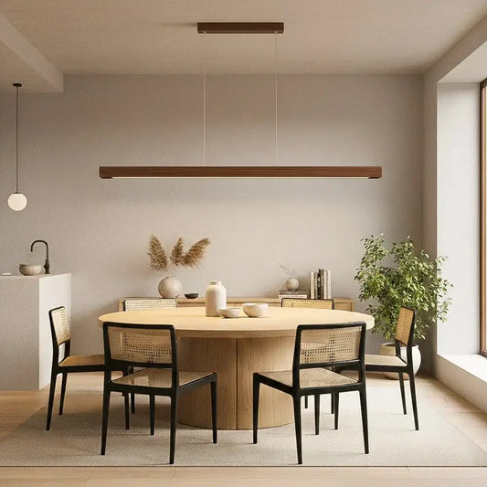 Modern wood led pendant light with cord pendant installation above a round light-toned wooden dining table