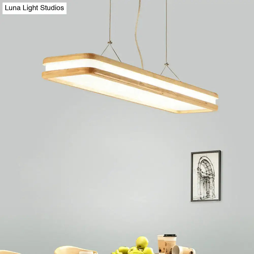 Modern wood rectangular hanging island lamp with natural wood frame and white led panel, emitting warm glow for dining room