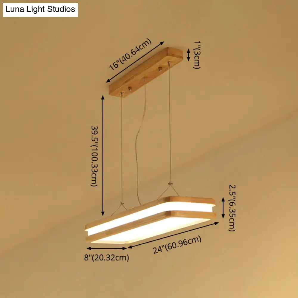 Modern wood rectangular hanging island lamp with warm white led glow framed by natural wood suspended by thin cords