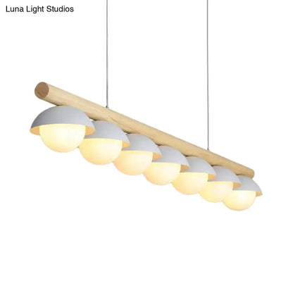 Decorbites modern wood stem linear chandelier with seven white shade dome lights emitting warm illumination