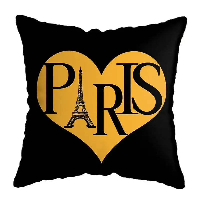 Black throw pillow with bold yellow heart and eiffel tower outline, ideal complement to geometric deer print decor