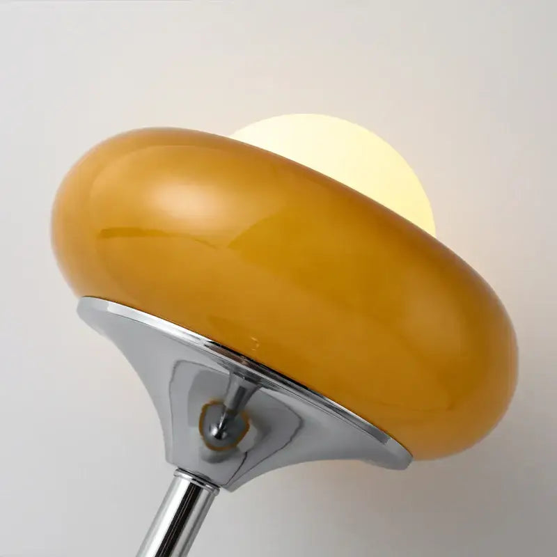 Modern yellow and chrome glass egg tart desk lamp with amber glass lampshade and polished chrome base for bedroom use