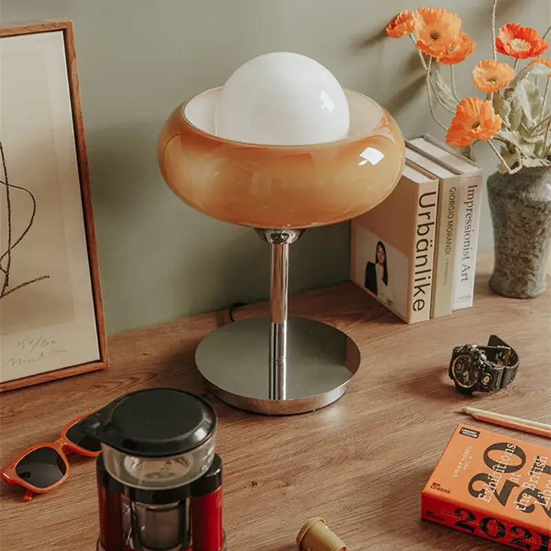 Modern yellow and chrome glass egg tart desk lamp with a translucent amber glass base and white spherical shade for bedroom