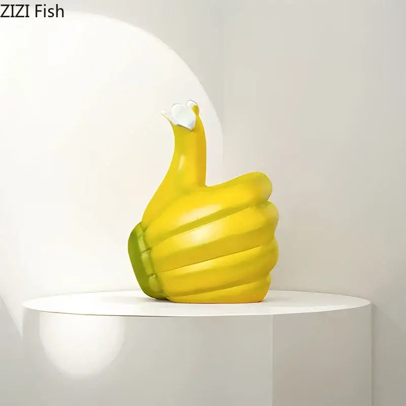 Modern yellow banana fist resin statue desk ornament shaped like an inflatable thumbs-up hand with green wristband and white heart