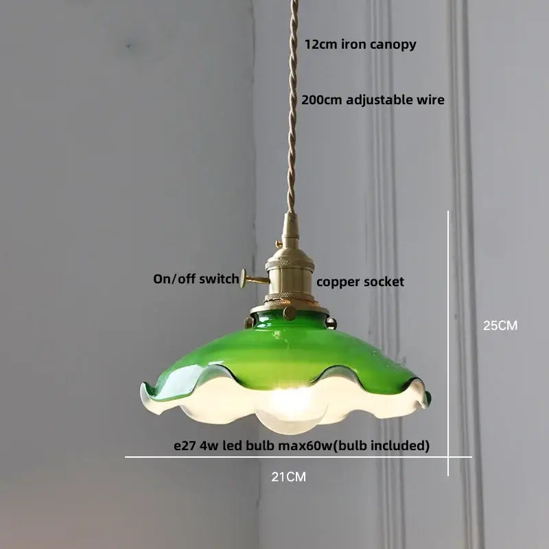 Green glass pendant light with scalloped edge and brass components complements modern yellow pendant light with decorbites copper knob iron