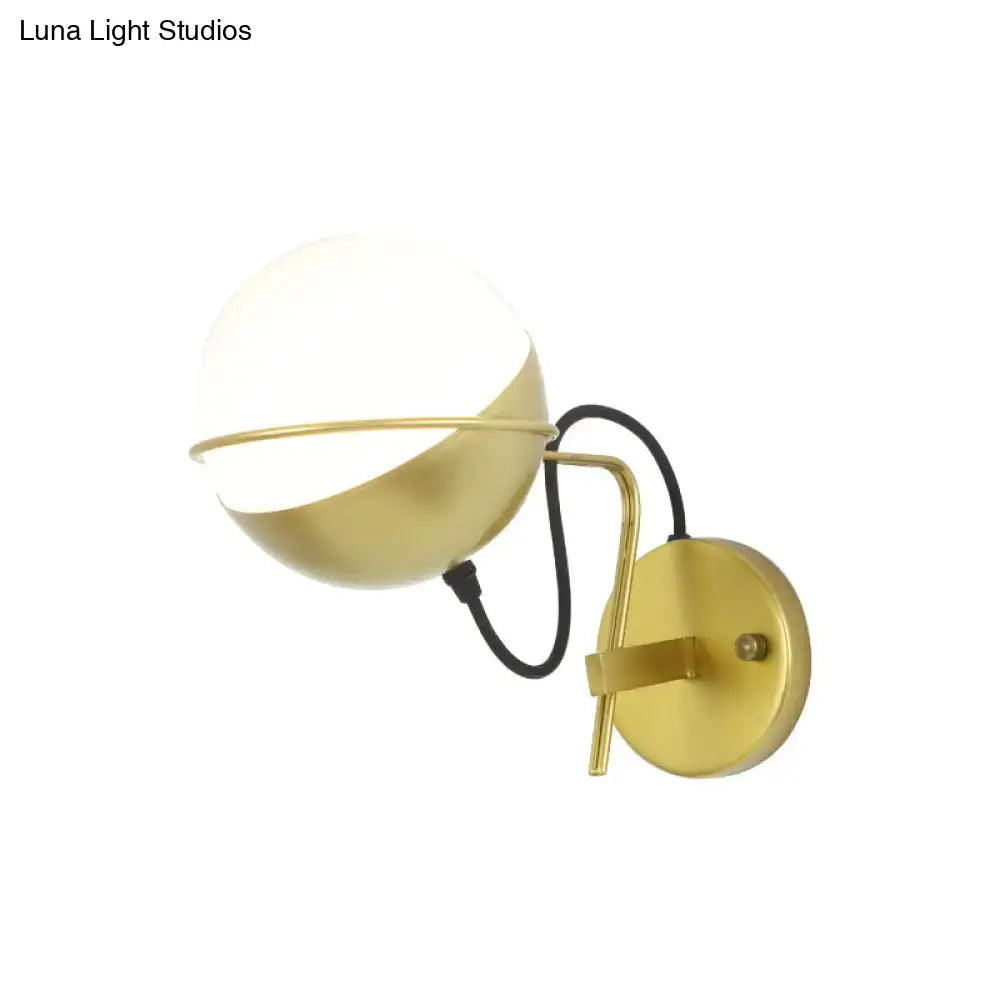 Modern yellow globe wall sconce with gold finish white glass globe diffuser and black cord for bedroom lighting