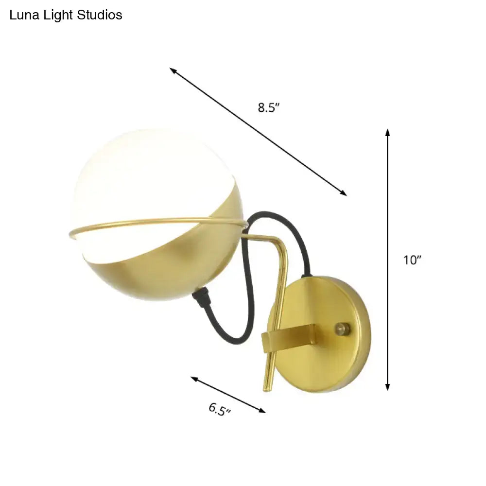 Modern yellow globe wall sconce with gold finish, white glass globe shade, and curved metal arm for bedroom lighting