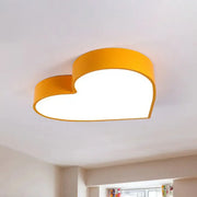 Bright yellow heart-shaped led flush mount ceiling light with smooth acrylic design for bedroom decor by DecorBites