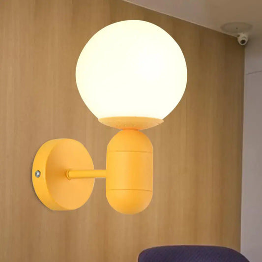 A bright yellow modern metal fixture wall lamp with frosted glass orb shade for 220v-240v installation