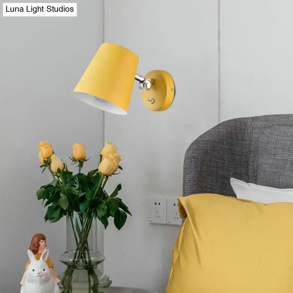 Modern yellow metal shade sconce light with conical design and adjustable arm for bedroom wall mounting