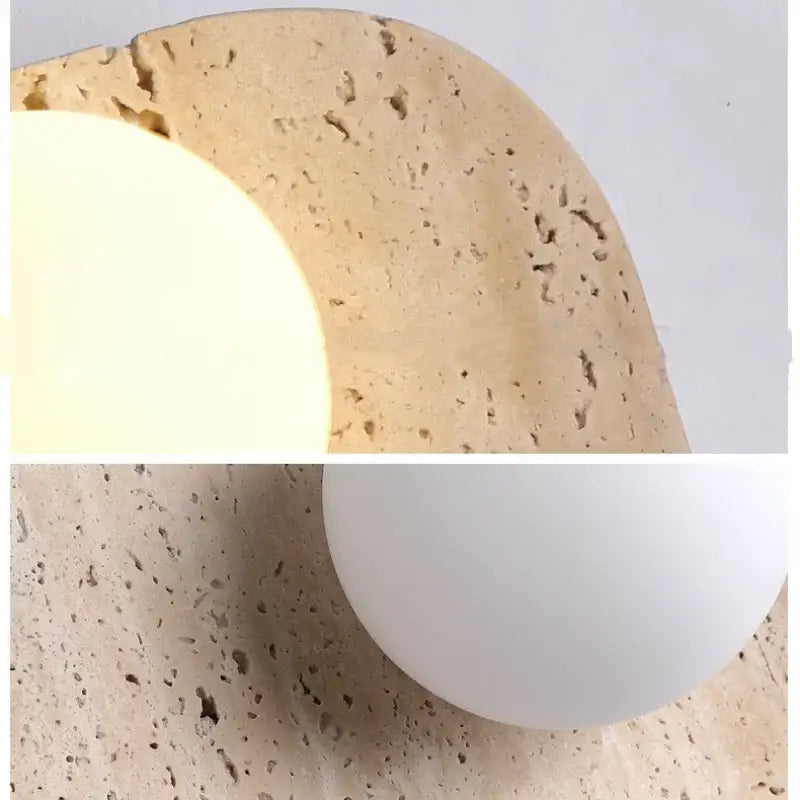 Modern yellow travertine led wall lamp with beige textured stone base and frosted white spherical shade for bedroom use