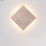 Modern yellow travertine square led wall lamp sconce with textured light beige surface and subtle embedded speckles