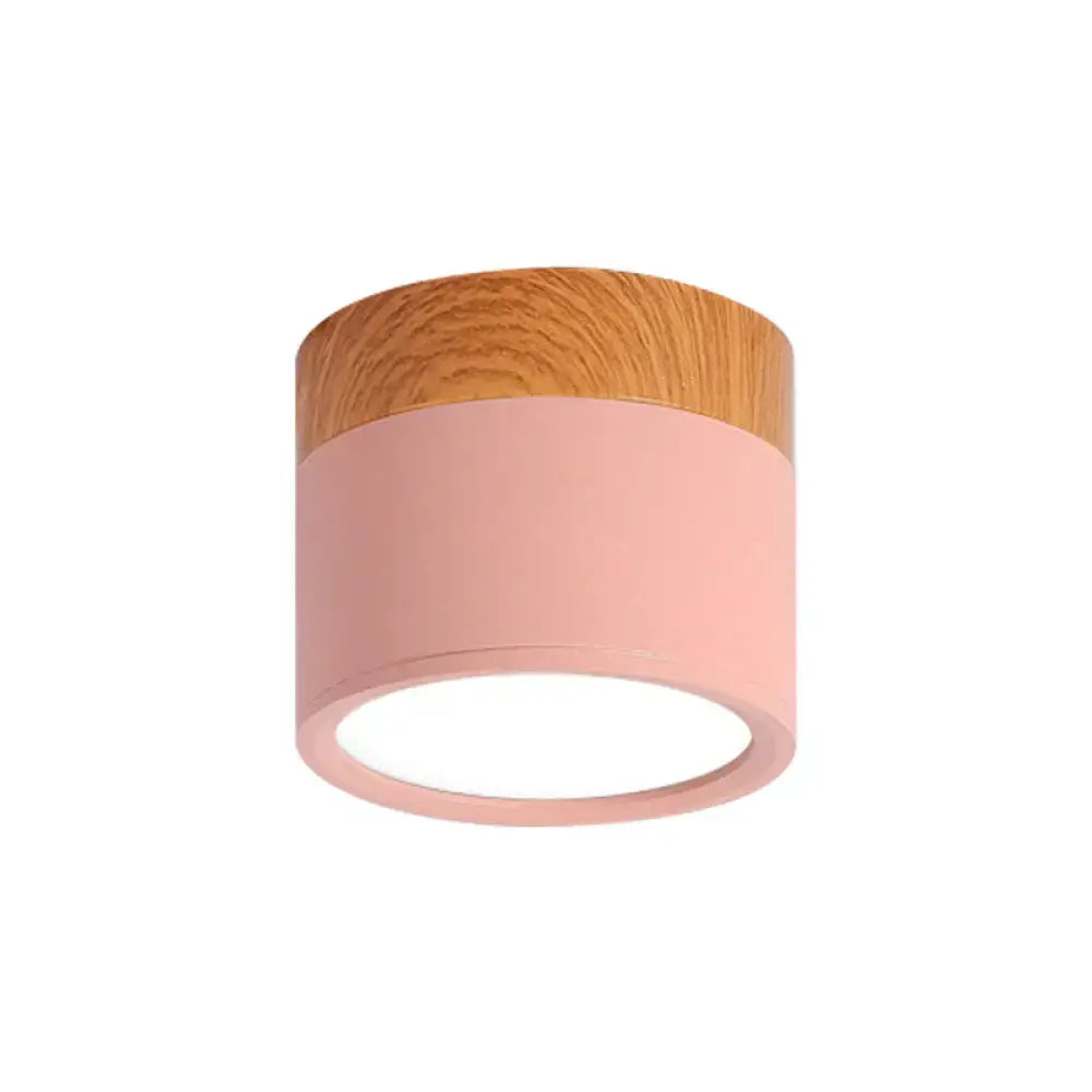 A decorbites™ small macaron metal flush mount ceiling light with pink matte finish and natural wood top for kitchen bar