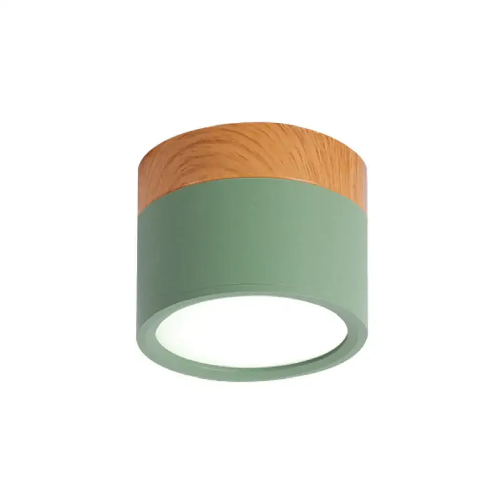 Modern flush mount ceiling light with matte sage green metal body natural wood top and integrated led ring