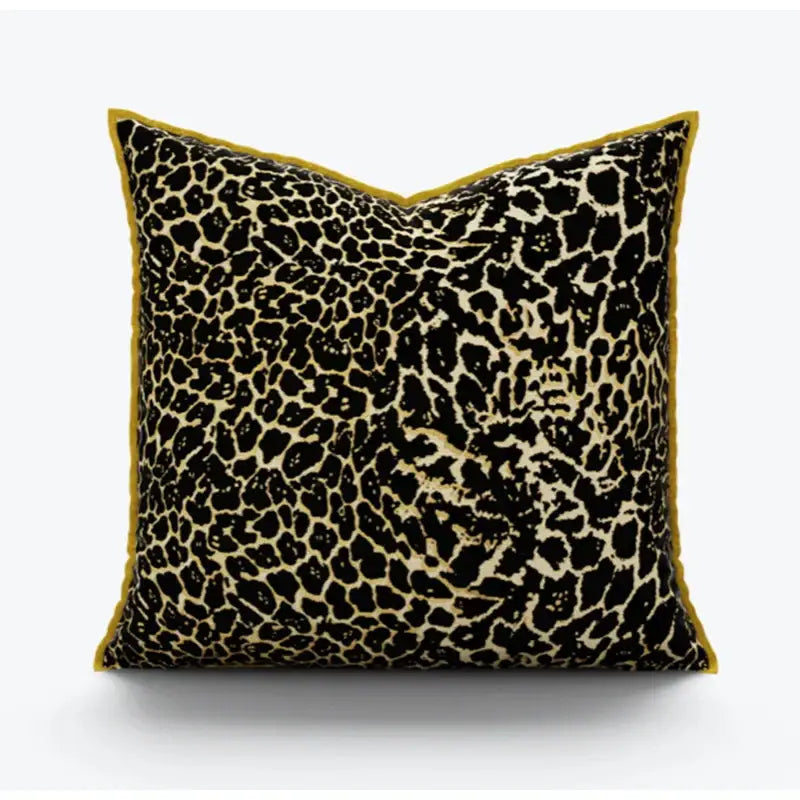 Square pillow cover with bold black and beige leopard print fabric and mustard-yellow velvet trim for decorbites gold zebra decor