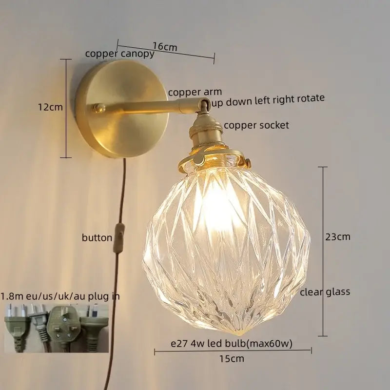 A vintage-style wall lamp with brass-finished copper and clear glass globe for warm light in bedroom lighting