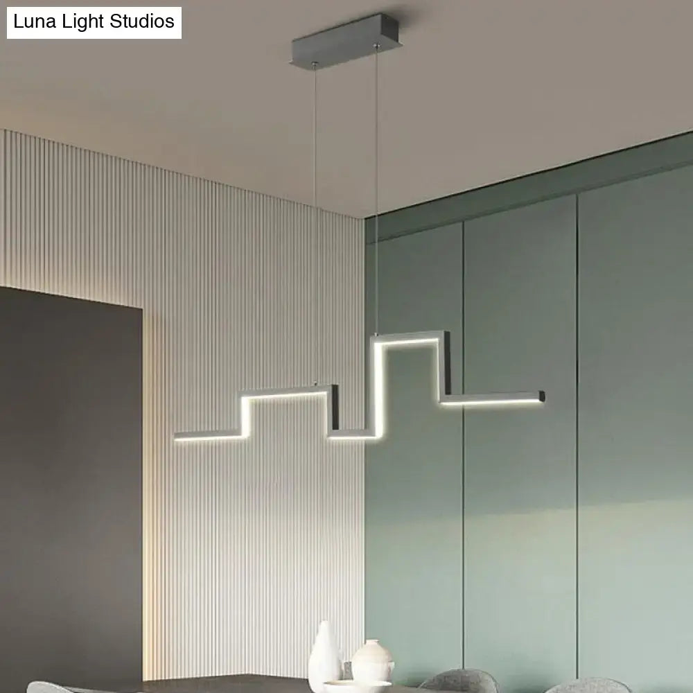 Modern zigzag linear metal hanging light fixture with illuminated edges for dining room use