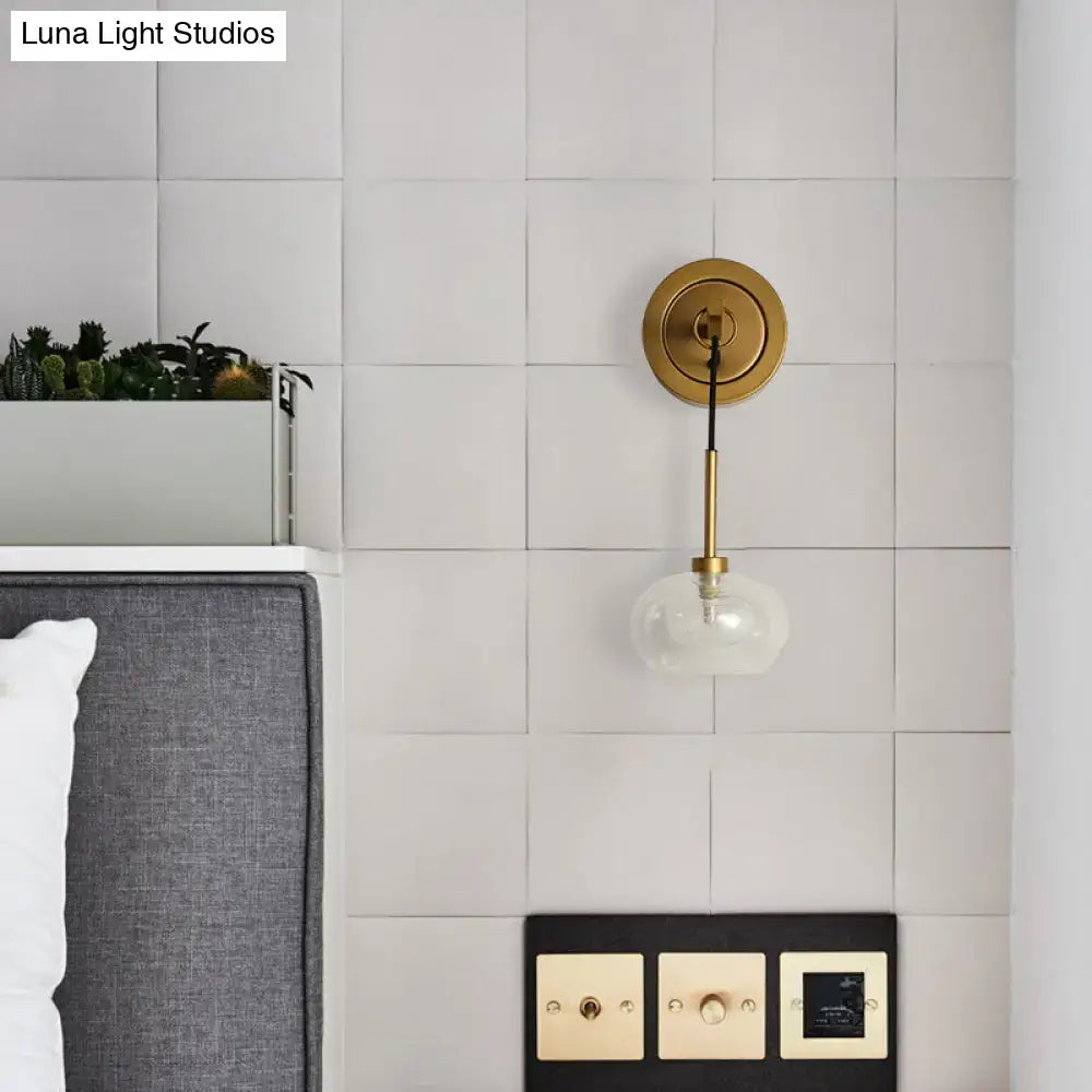 Gold-toned modernist amber white glass wall sconce with clear glass globe shade for bedroom satisfaction guarantee