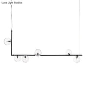 DecorBites modernist black metal chandelier with five clear glass globe bulbs and right angled frame in warm white lighting
