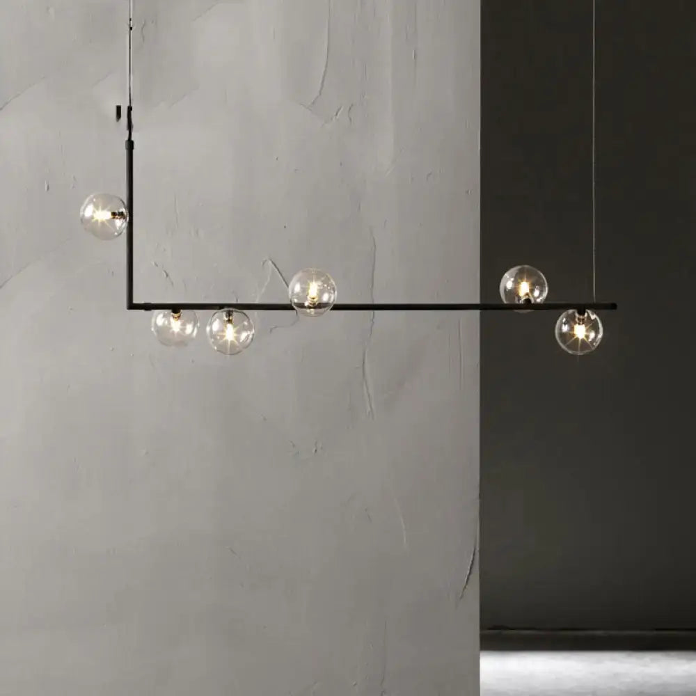 Modern black metal pendant light with five clear glass globe bulbs and a right angled frame for warm white lighting