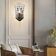 Modernist black and gold wall sconce featuring a clear crystal panel with textured glass and led incandescent fluorescent options