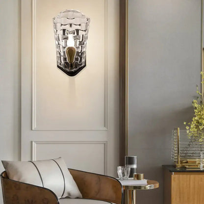 Modernist black and gold wall sconce featuring a clear crystal panel with textured glass and led incandescent fluorescent options